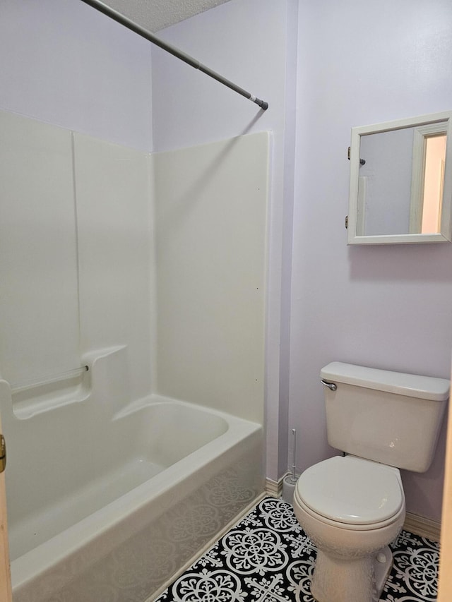946 Ashley Ln Unit C, Fort Walton Beach, FL 32547 - bathroom featuring shower / bathtub combination, toilet, tile patterned flooring, and baseboards