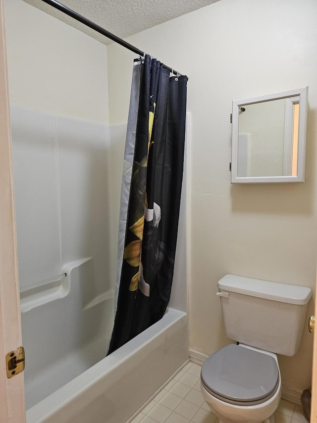 946 Ashley Ln Unit C, Fort Walton Beach, FL 32547 - bathroom with shower / bath combo, tile patterned floors, toilet, a textured ceiling, and baseboards