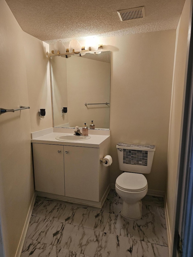 946 Ashley Ln Unit C, Fort Walton Beach, FL 32547 - half bath with marble look tiles, vanity, baseboards, toilet, and a textured ceiling