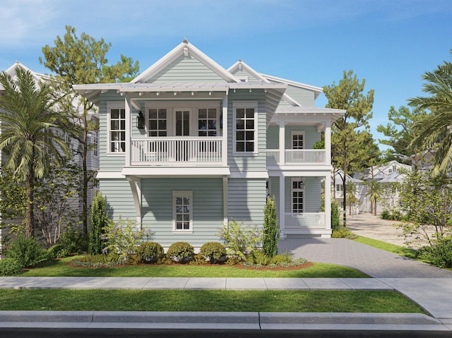 beach home featuring metal roof, a standing seam roof, and a balcony