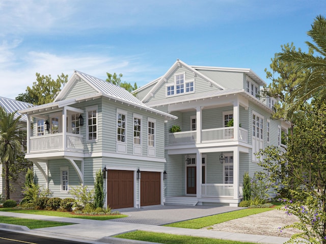 view of front of house with metal roof, a porch, a balcony, driveway, and a standing seam roof