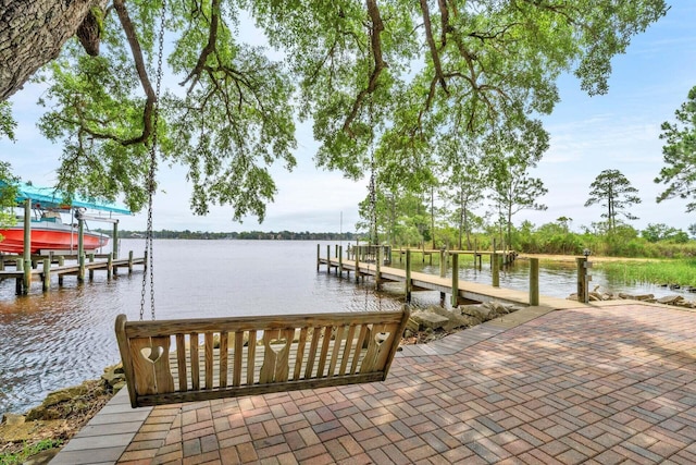 dock area with a water view and boat lift