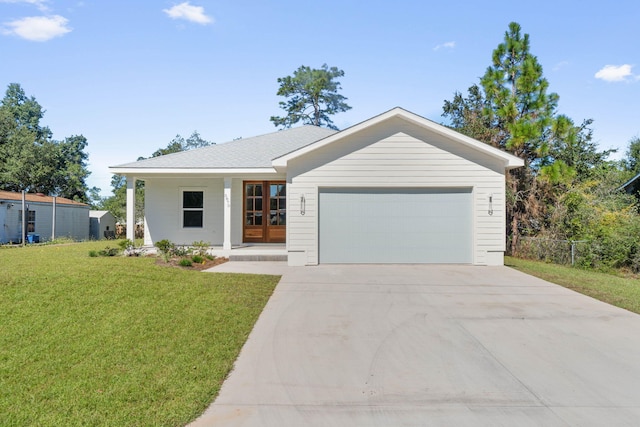 ranch-style home with an attached garage, driveway, a front lawn, and fence