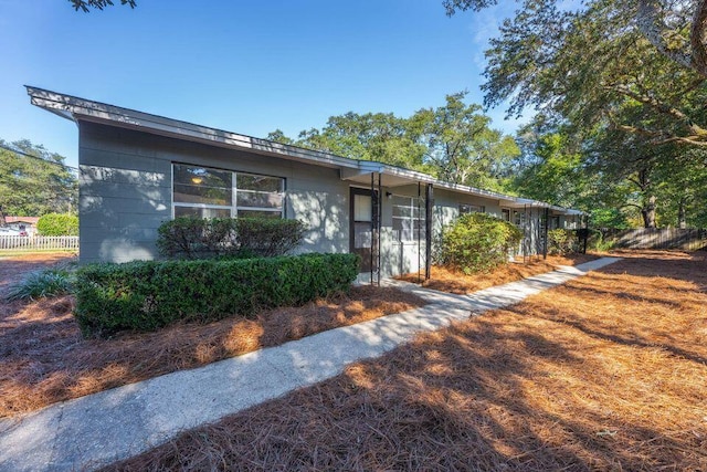 single story home with fence