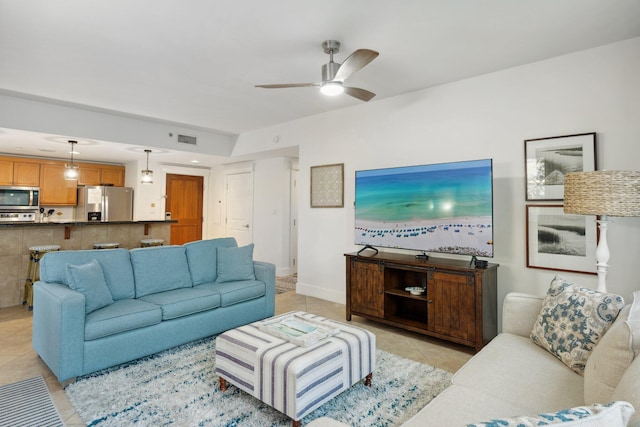 living room with light tile patterned floors, baseboards, visible vents, and ceiling fan