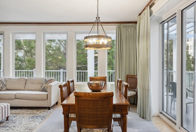 dining area featuring an inviting chandelier, light tile patterned floors, and a healthy amount of sunlight