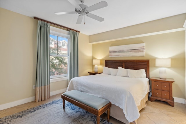 bedroom featuring light tile patterned flooring, a ceiling fan, and baseboards