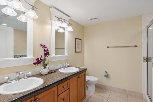 bathroom with tile patterned floors, visible vents, toilet, and a sink