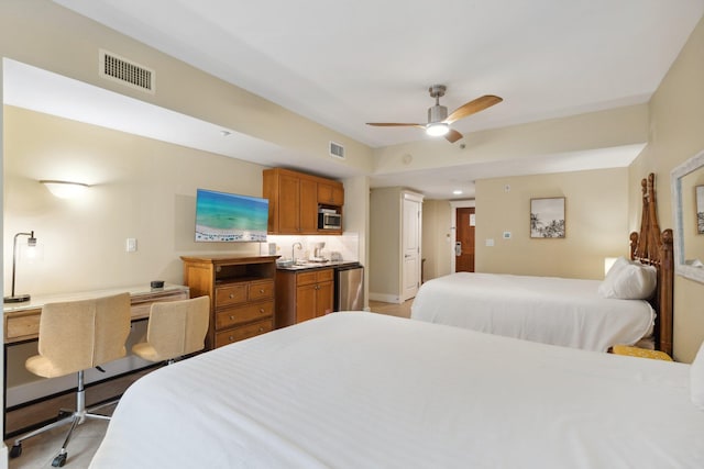 bedroom with a sink, visible vents, baseboards, and ceiling fan