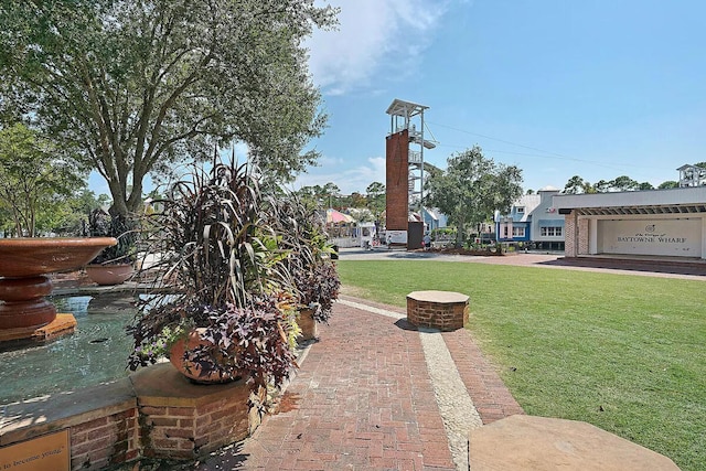 view of home's community with a yard