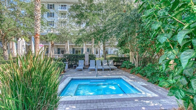 view of swimming pool with a swimming pool, a patio, and fence