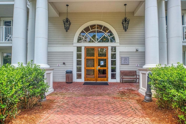 entrance to property featuring french doors and covered porch