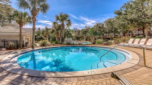 pool featuring a patio and fence