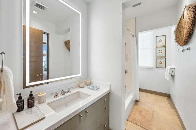 bathroom with tile patterned floors, visible vents, shower / tub combo with curtain, baseboards, and vanity