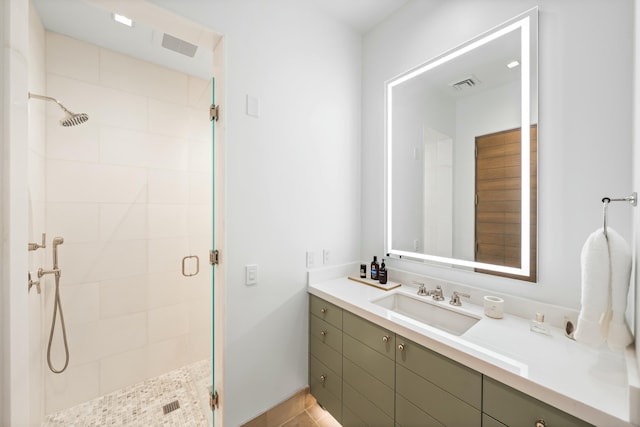 bathroom with visible vents, a stall shower, and vanity