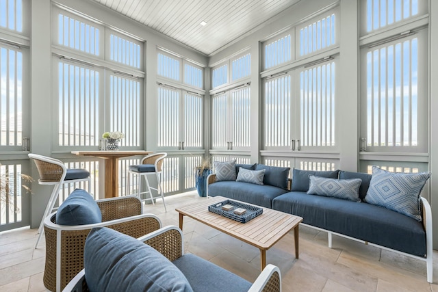 sunroom with a healthy amount of sunlight and wooden ceiling