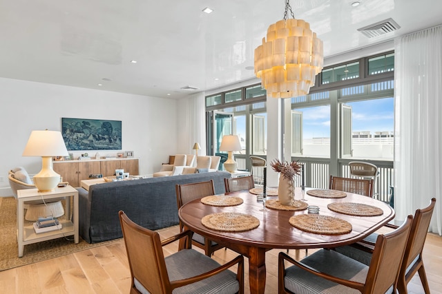 dining space featuring light wood-style flooring, recessed lighting, visible vents, and a wealth of natural light