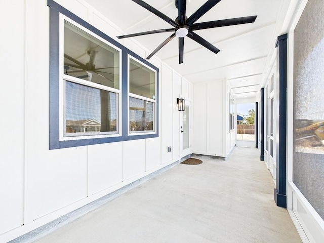 unfurnished sunroom with a ceiling fan