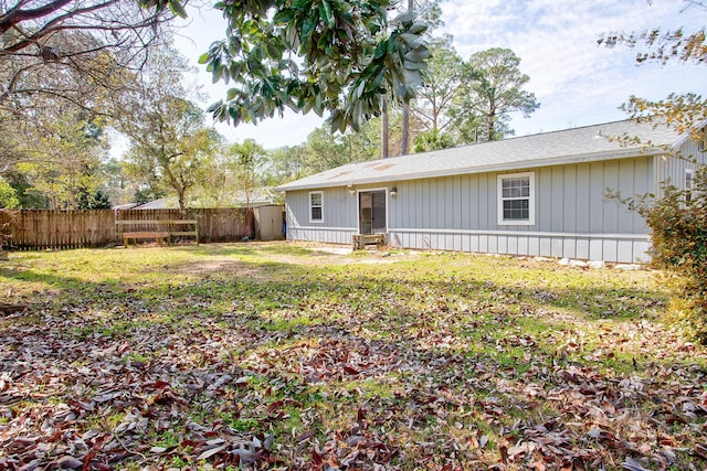 exterior space featuring fence private yard and a lawn