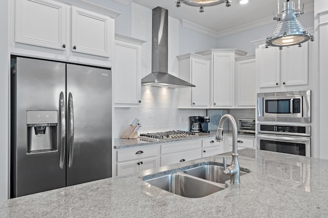 kitchen with a sink, appliances with stainless steel finishes, wall chimney range hood, ornamental molding, and tasteful backsplash