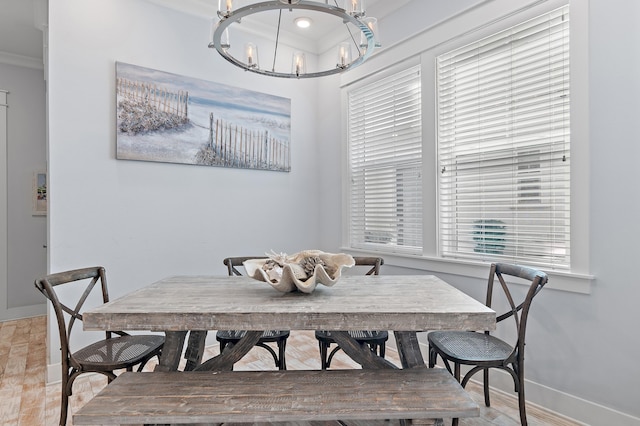 dining room with baseboards, a chandelier, and ornamental molding