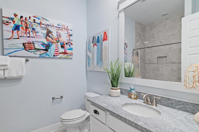 full bathroom with toilet, baseboards, a shower, and vanity