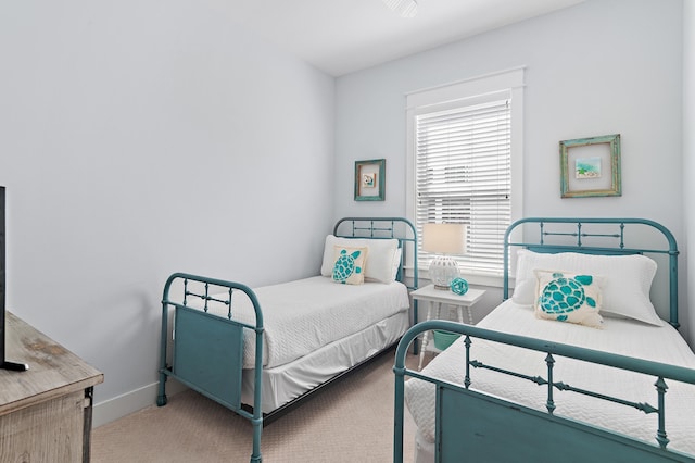 bedroom featuring carpet and baseboards