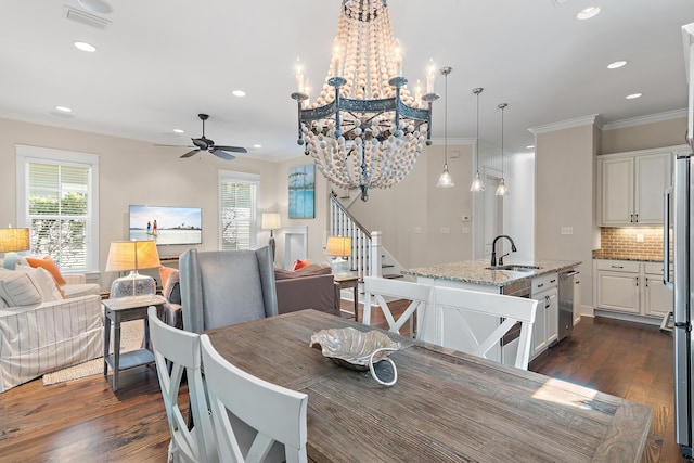 dining room with ornamental molding, a healthy amount of sunlight, and visible vents