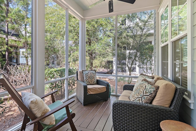 sunroom / solarium featuring a ceiling fan