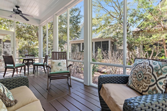 sunroom / solarium featuring ceiling fan