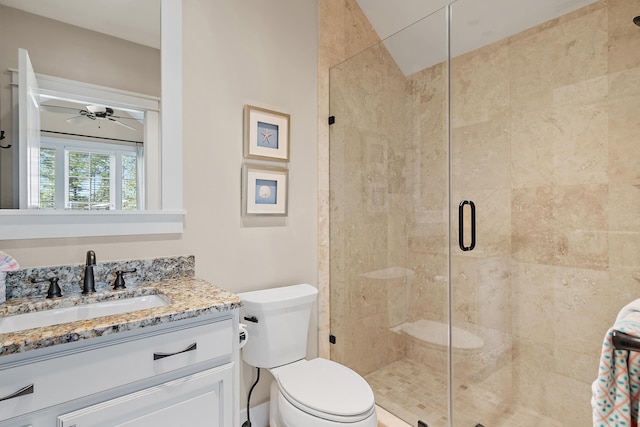 full bathroom with toilet, a shower stall, ceiling fan, and vanity