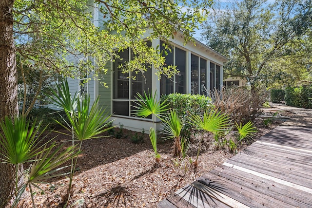 view of property exterior featuring a sunroom