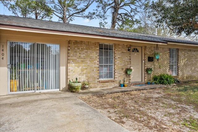 entrance to property featuring brick siding