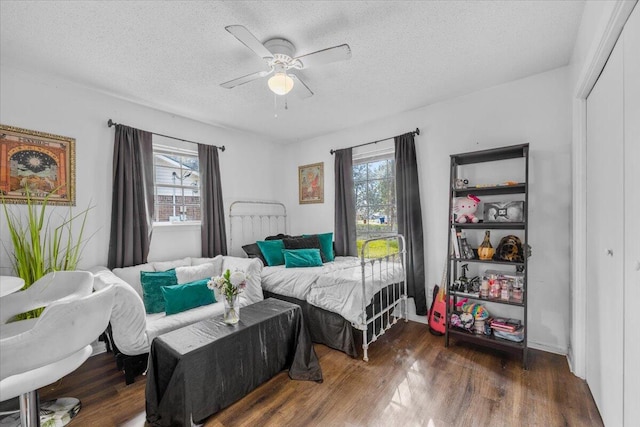 bedroom with a closet, a textured ceiling, and wood finished floors