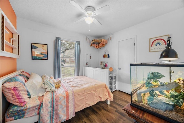 bedroom with a textured ceiling, a ceiling fan, and wood finished floors