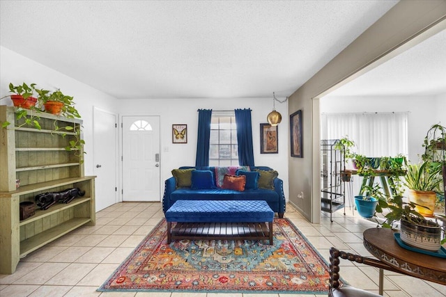 living room with light tile patterned floors and a textured ceiling