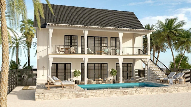 rear view of property with a balcony, stairway, fence, a tile roof, and a patio area