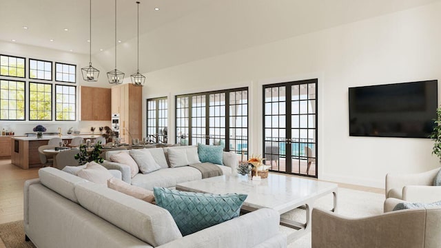 living room with light wood finished floors, recessed lighting, a high ceiling, and baseboards