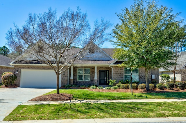 view of front of property with brick siding, driveway, an attached garage, and a front lawn