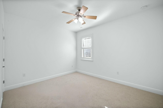 unfurnished room featuring light carpet, ceiling fan, and baseboards