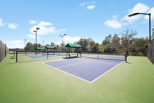 view of sport court featuring fence