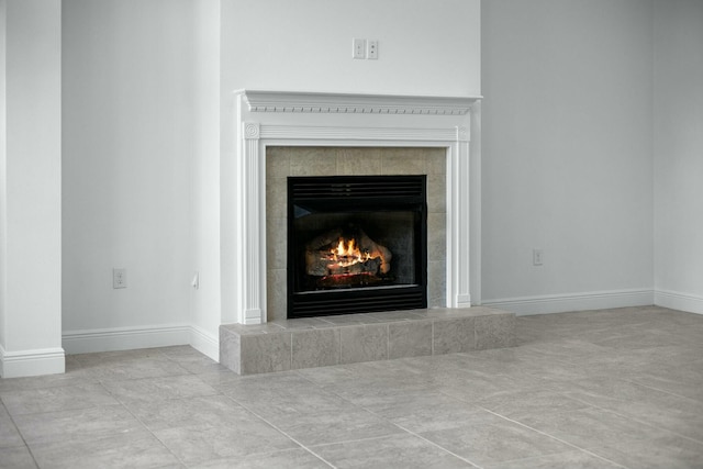 interior details featuring a fireplace and baseboards