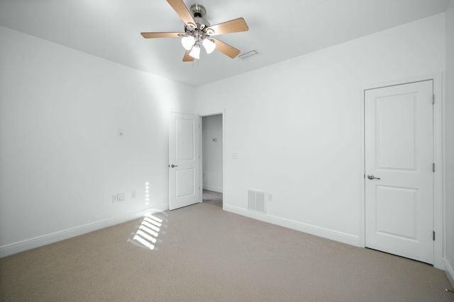 unfurnished bedroom with visible vents, carpet flooring, a ceiling fan, and baseboards