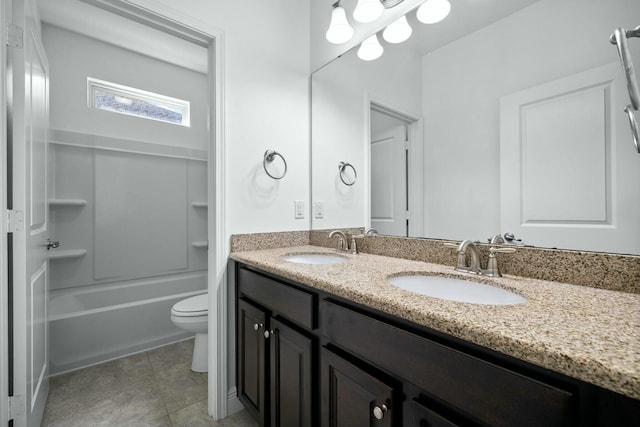 full bathroom with a sink, toilet, double vanity, and tile patterned floors