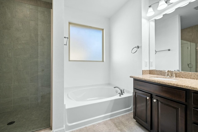 full bathroom featuring tile patterned floors, a stall shower, vanity, and a bath