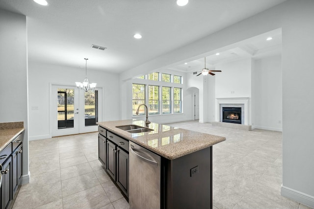 kitchen featuring stainless steel dishwasher, plenty of natural light, recessed lighting, and a sink