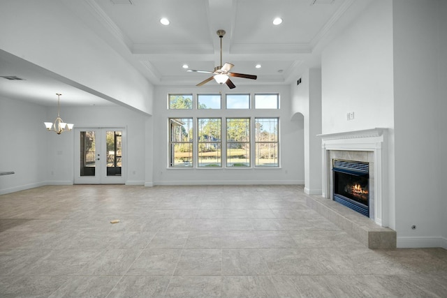 unfurnished living room with baseboards, ornamental molding, beam ceiling, a tile fireplace, and coffered ceiling