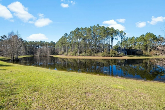 property view of water featuring a forest view