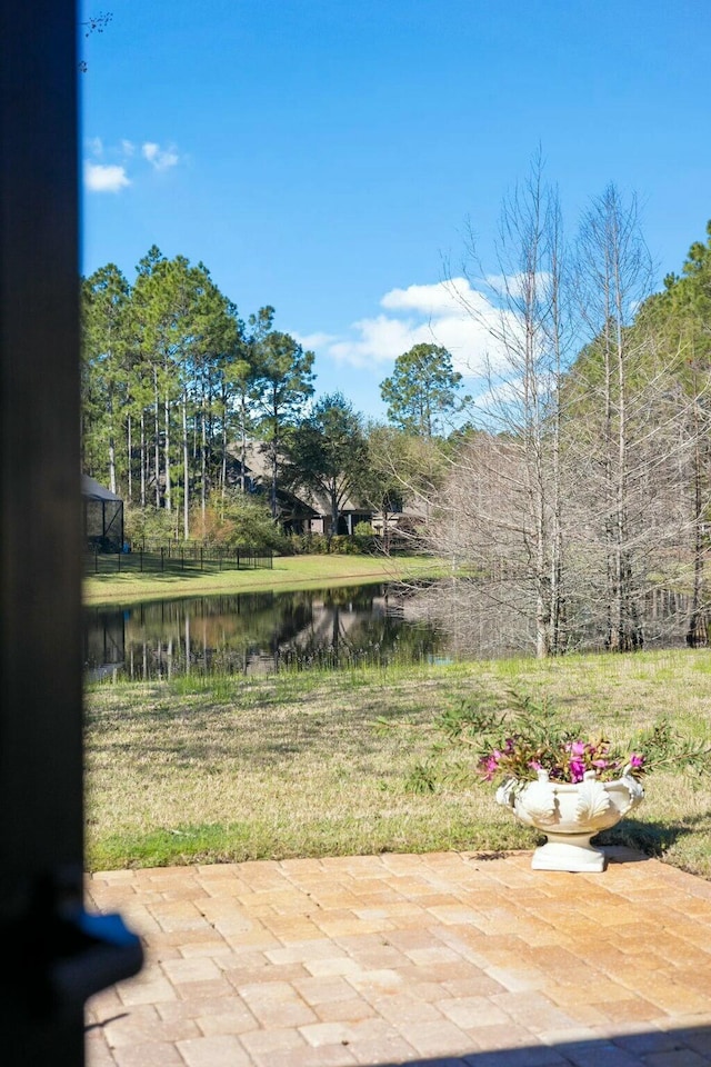 view of yard with a patio area and a water view