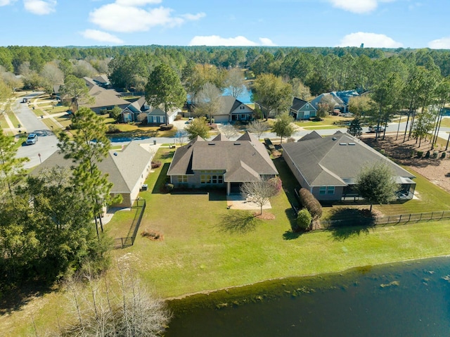 aerial view featuring a wooded view and a residential view